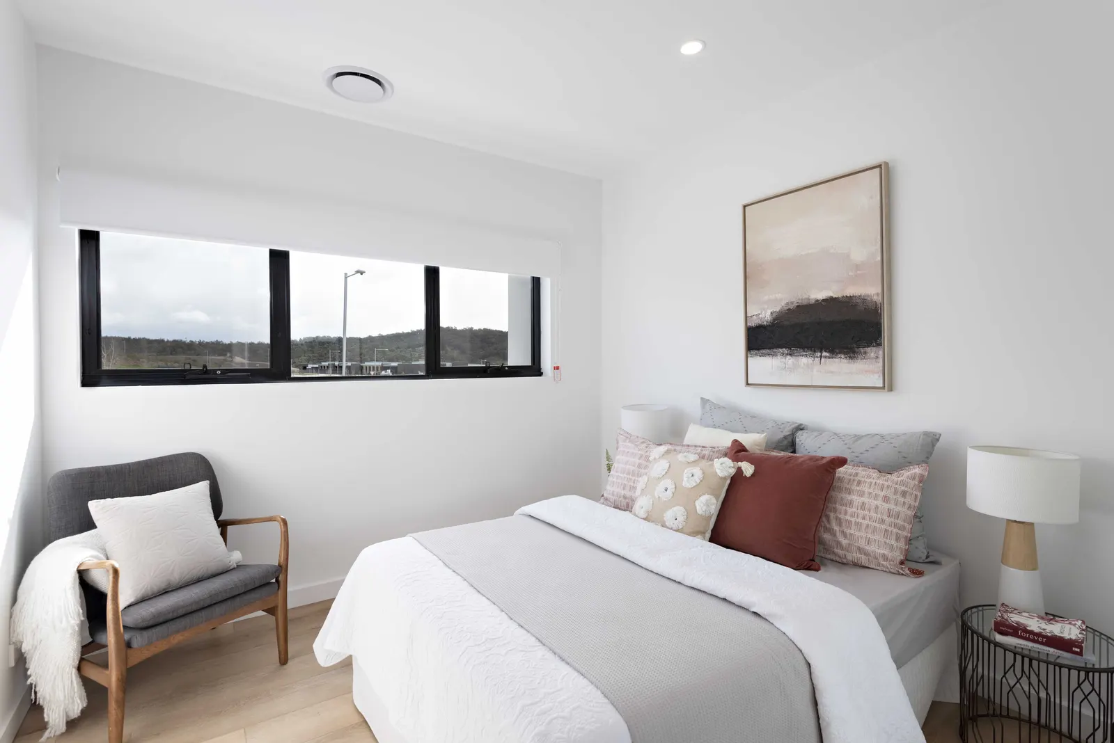Bedroom with wide highlight window and hills outlook