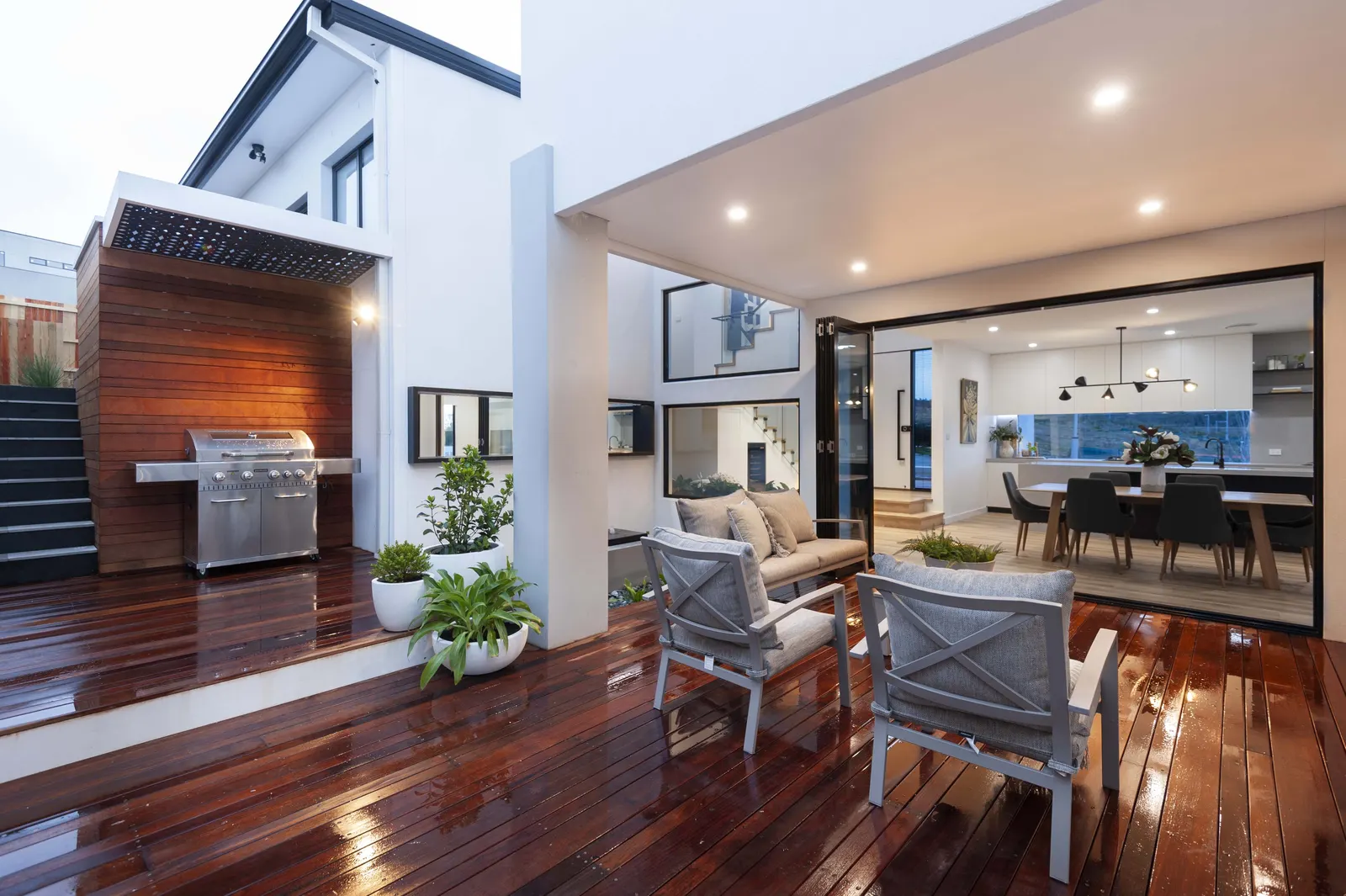 Covered alfresco deck with built in barbecue opening to the dining area