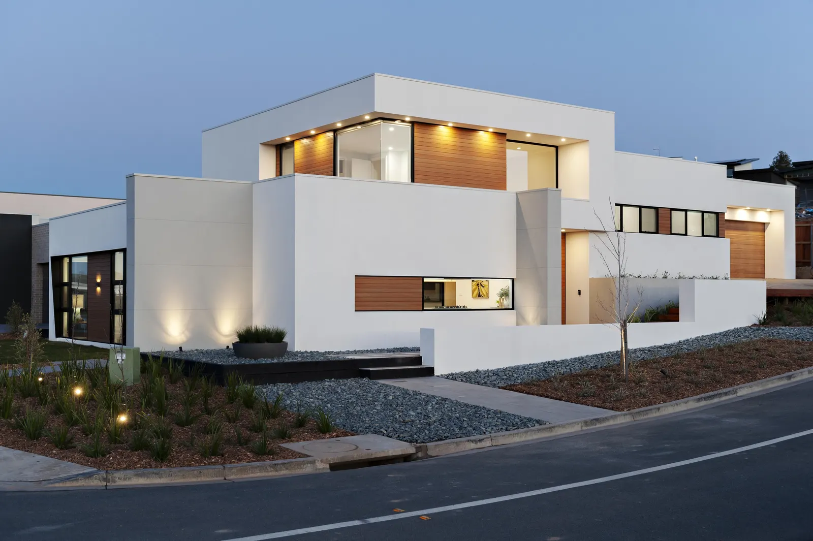 Contemporary two storey home exterior at twilight with timber accents, Canberra