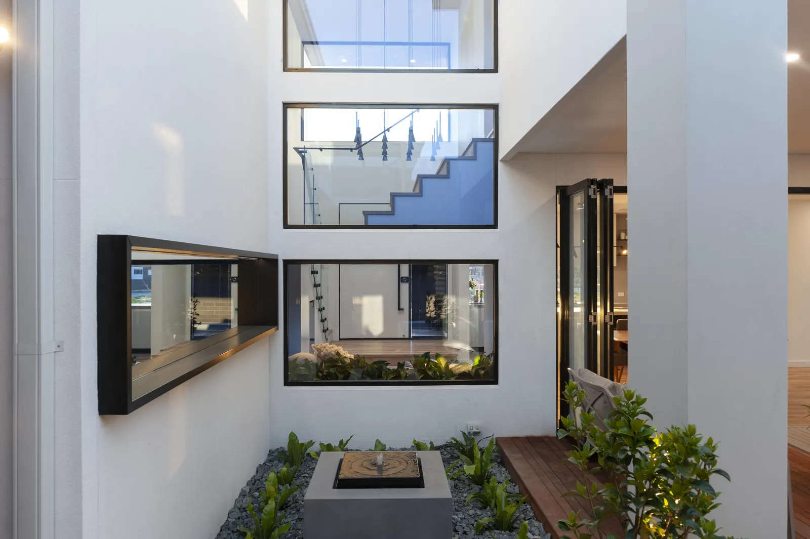 Internal courtyard with water feature and stacked feature windows