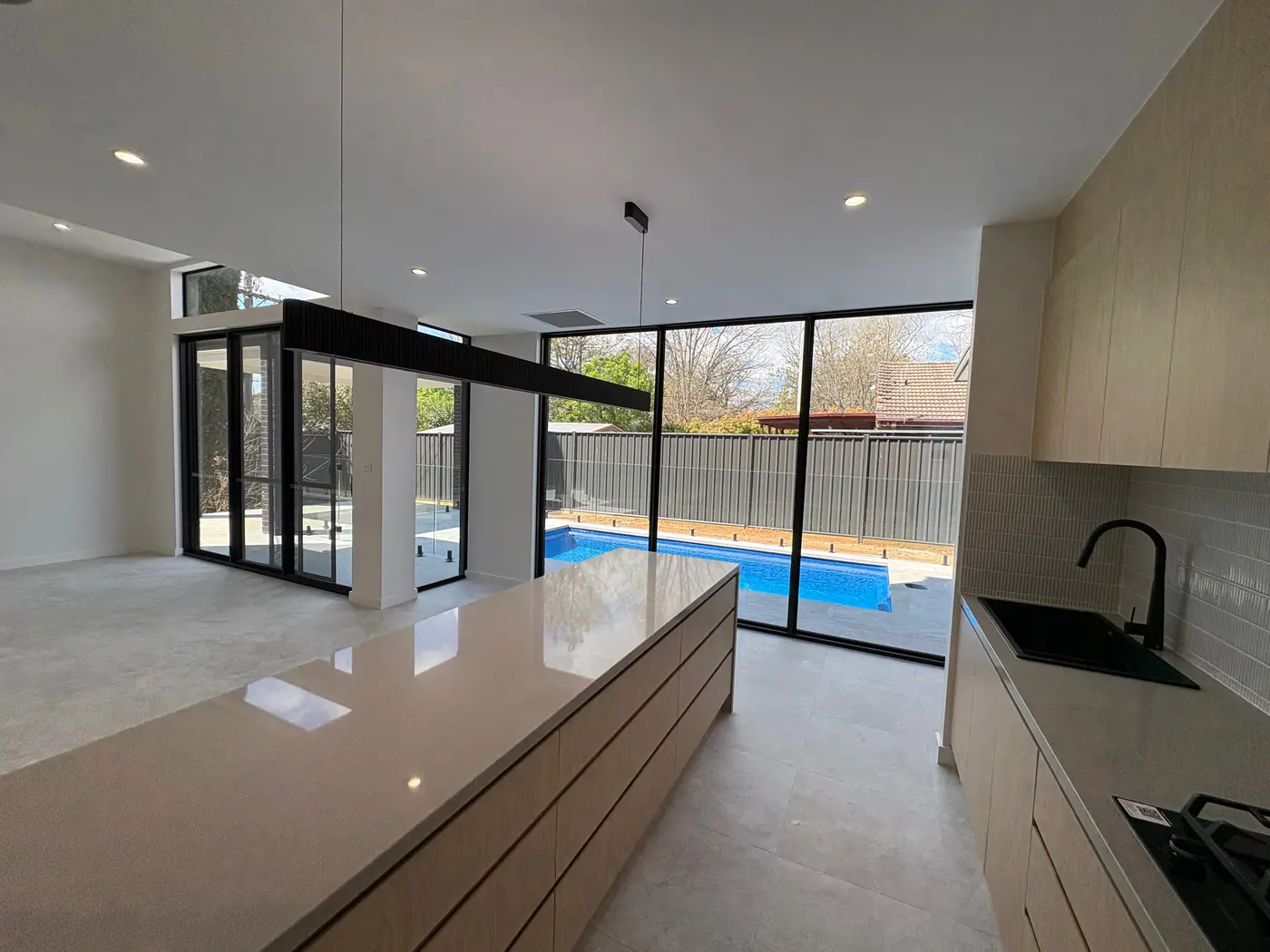 Kitchen overlooking the pool in the Narrabundah knockdown rebuild