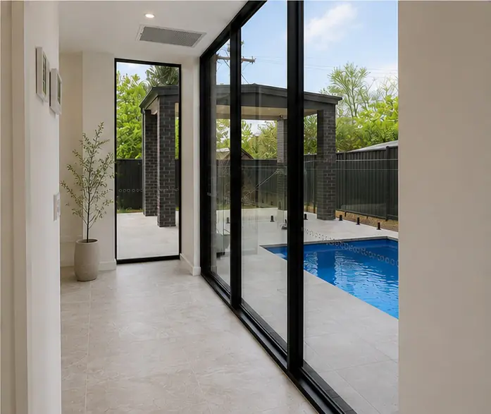 Glazed corridor overlooking the pool at the Narrabundah home