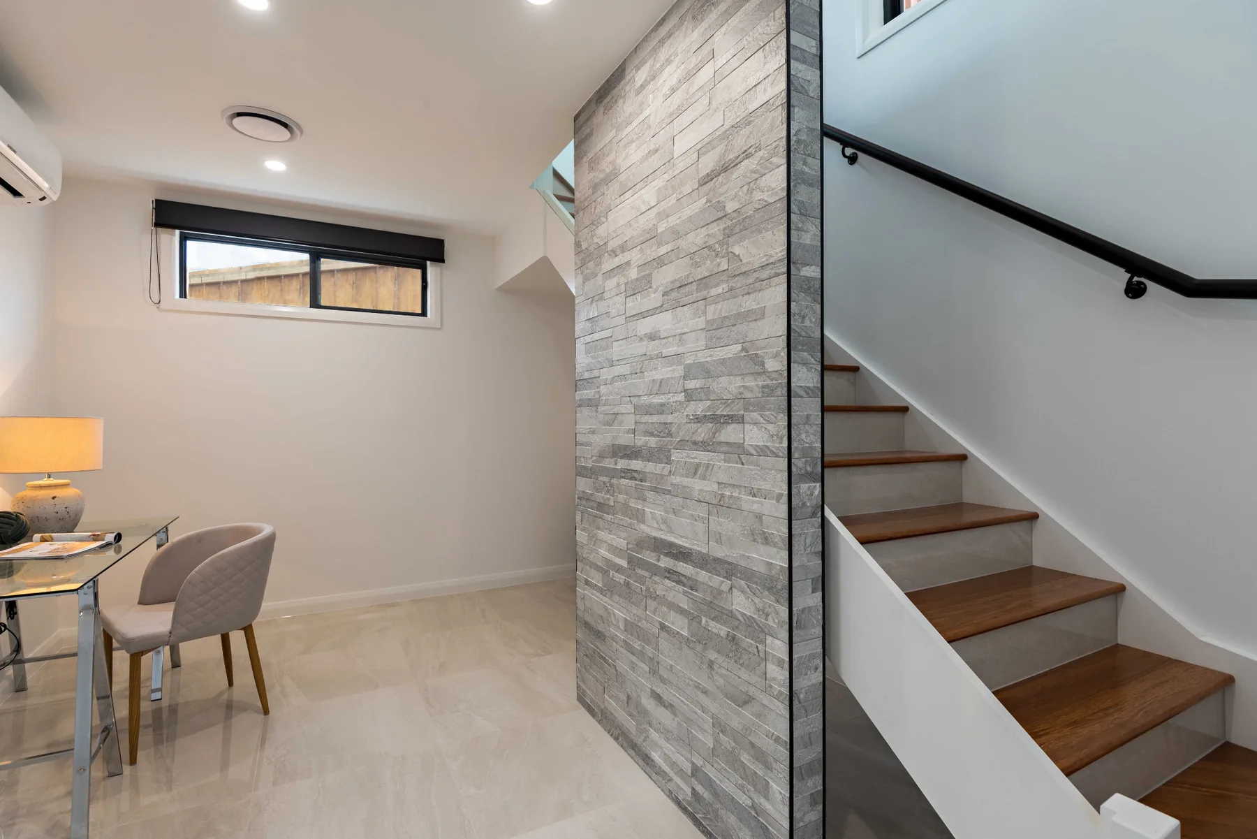Study nook and staircase with stone feature wall