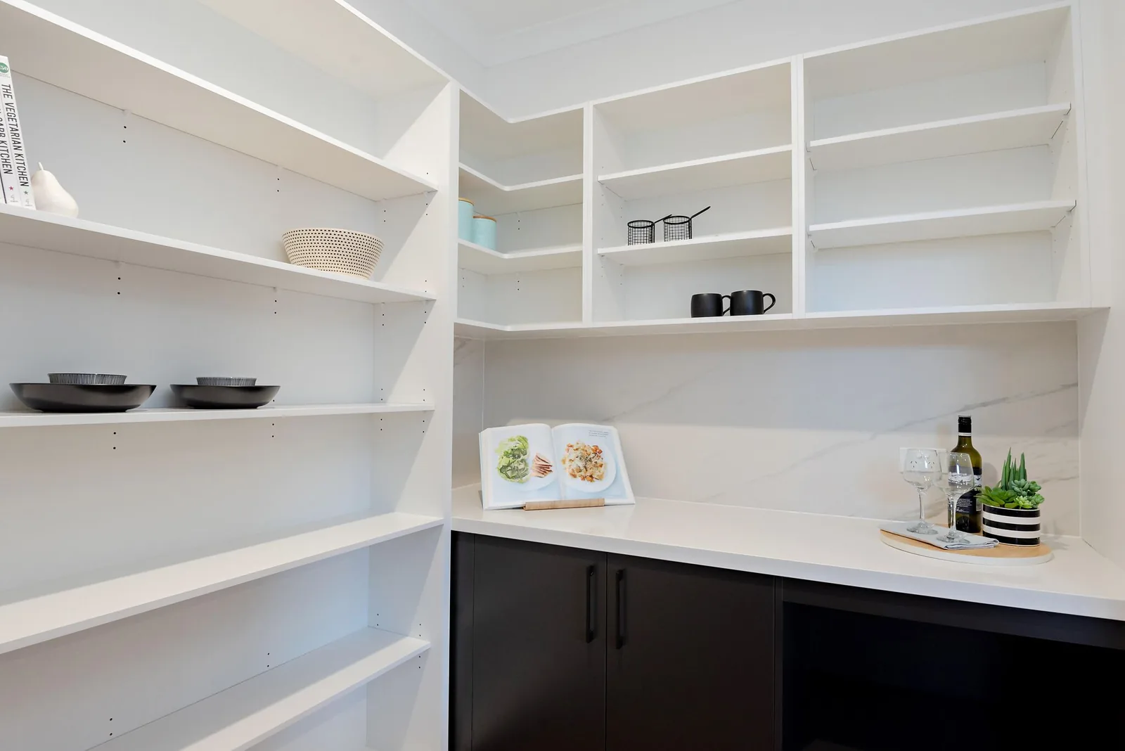 Walk in pantry with open shelving and stone benchtop