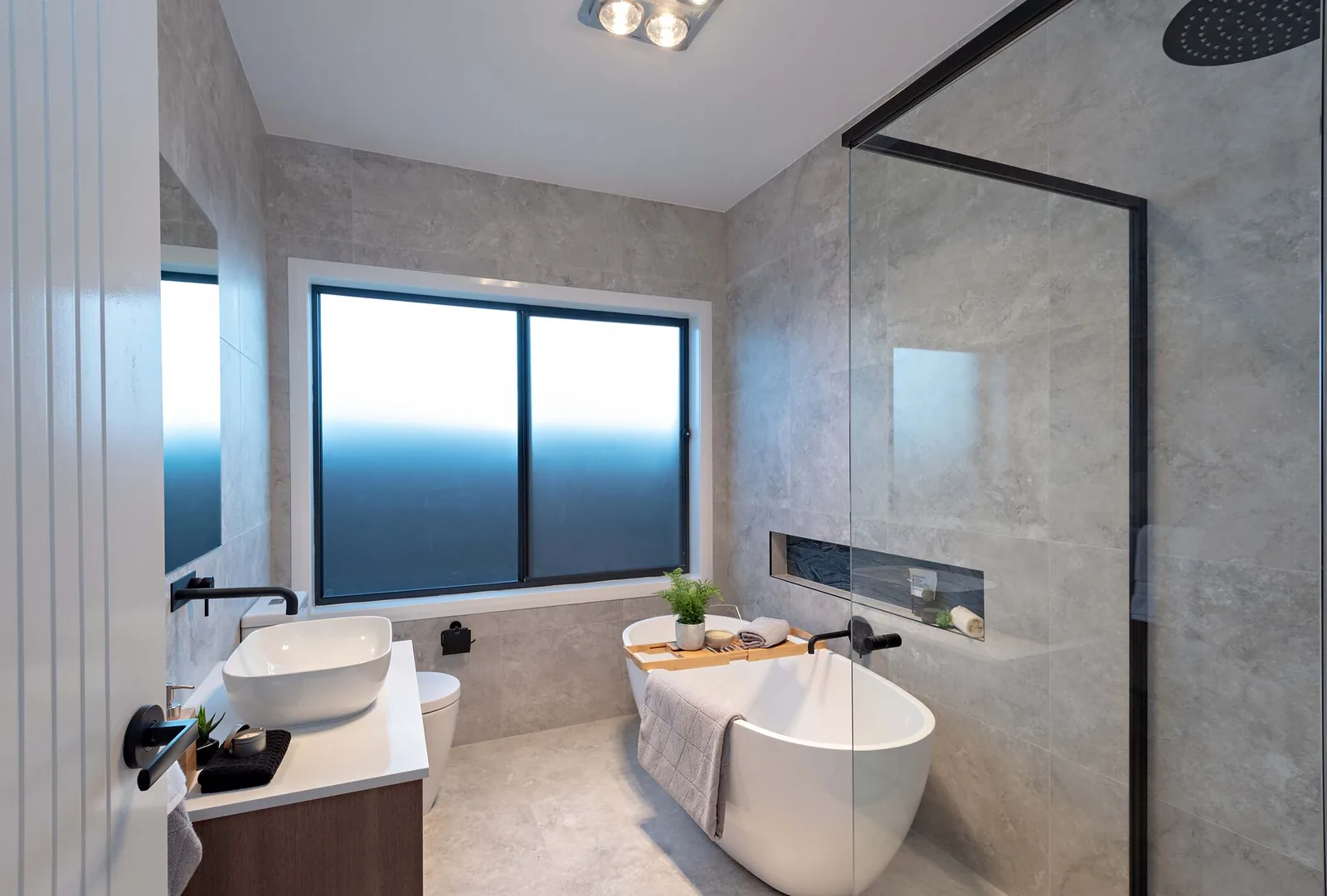 Main bathroom with freestanding bath, walk in shower and feature niche
