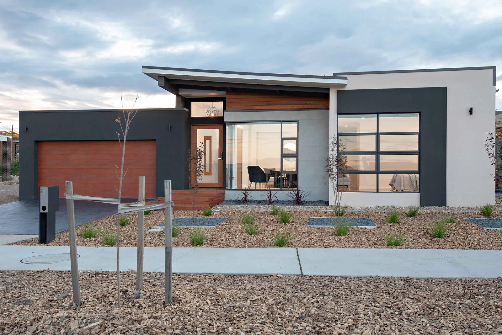 New home front exterior at dusk in Taylor by Ottimo Homes