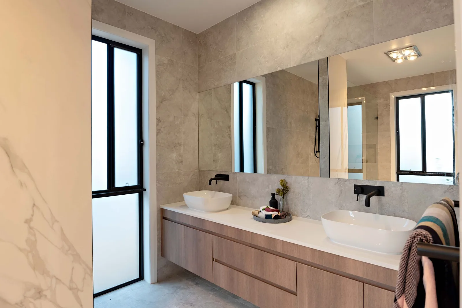 Ensuite with double vanity, timber cabinetry and matte black tapware