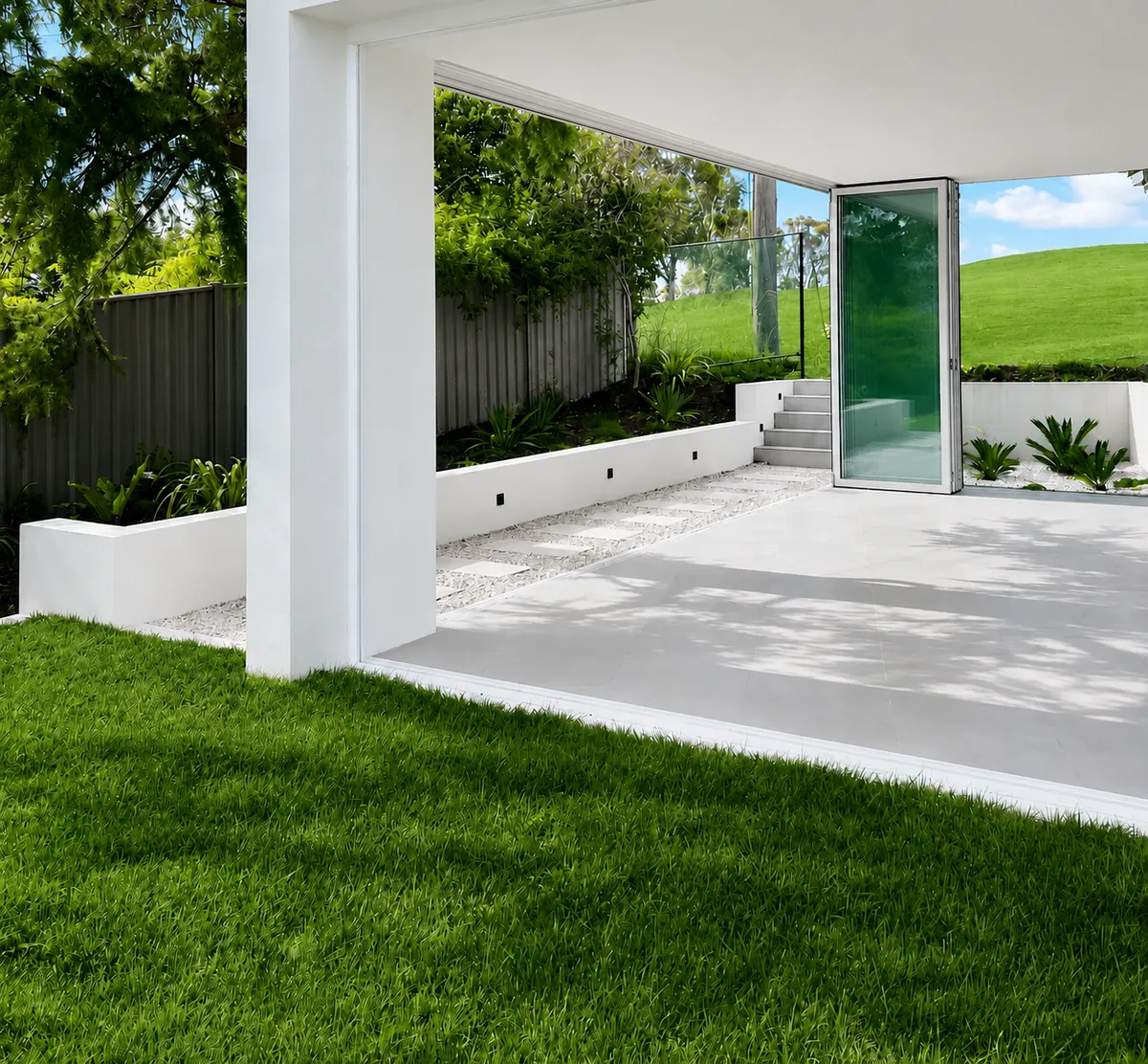 Covered outdoor room leading to a glazed pivot entry door