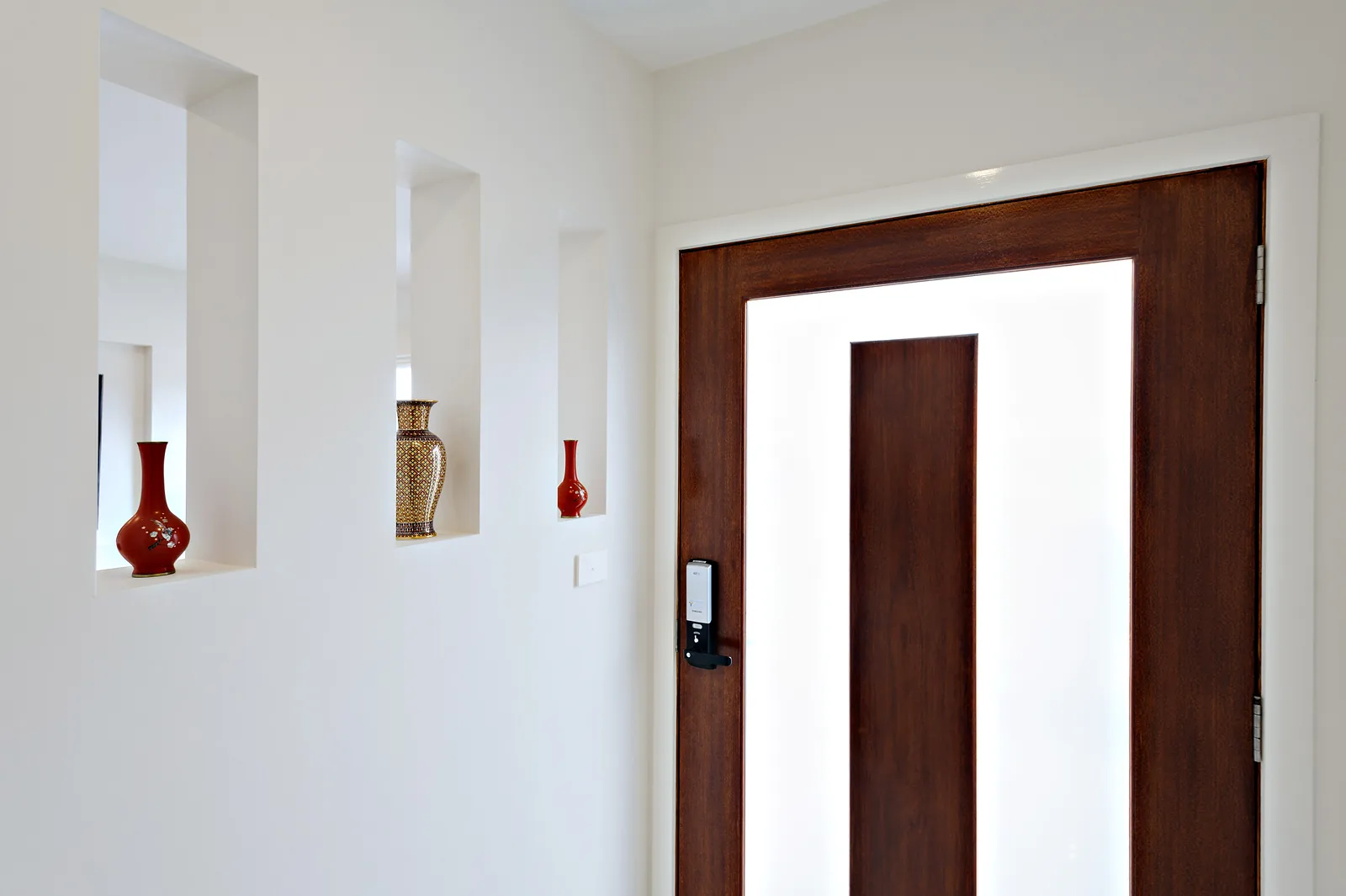 Entry hall with solid timber front door and recessed display niches