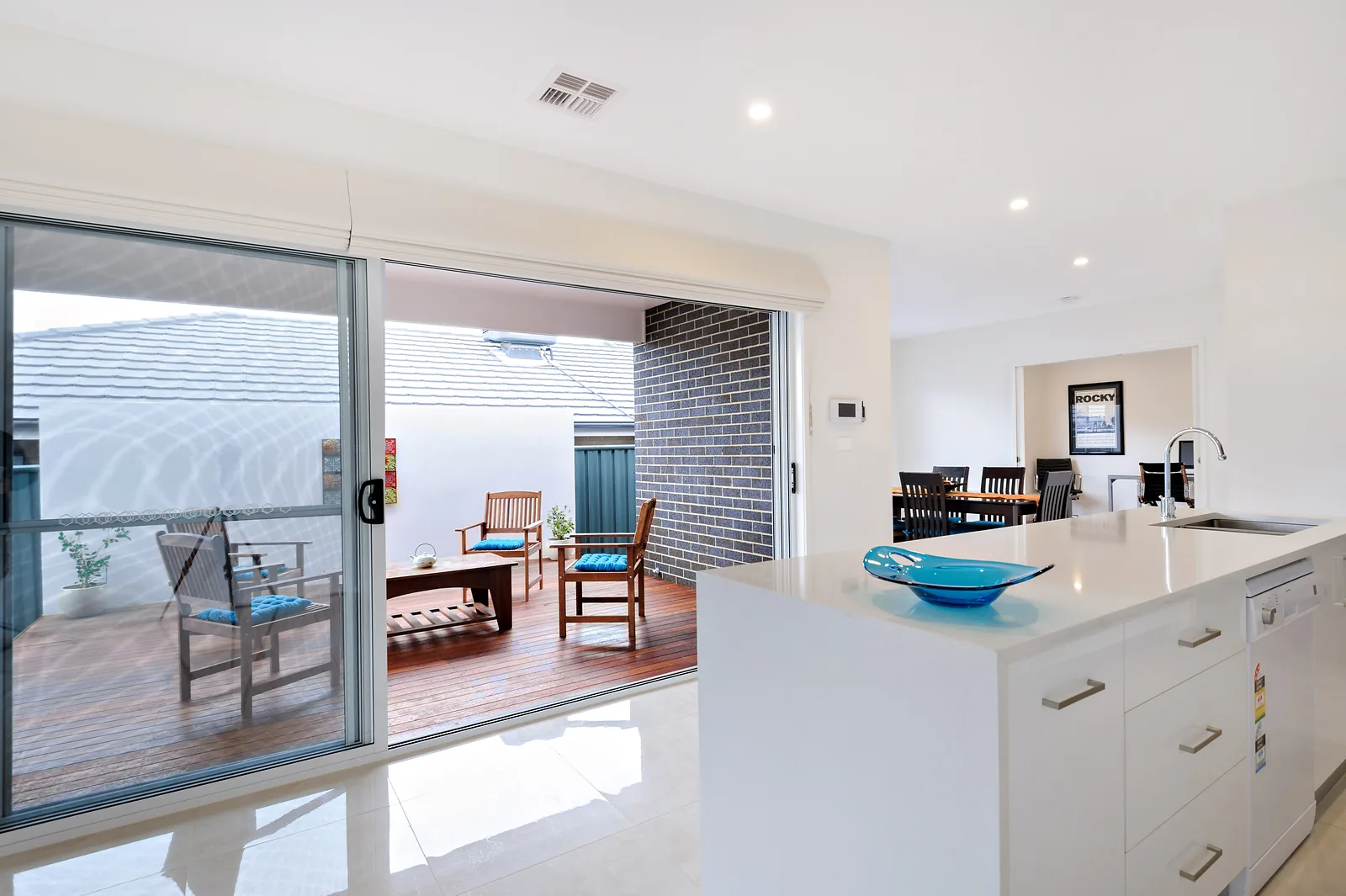 Kitchen servery window sliding open to the covered alfresco deck