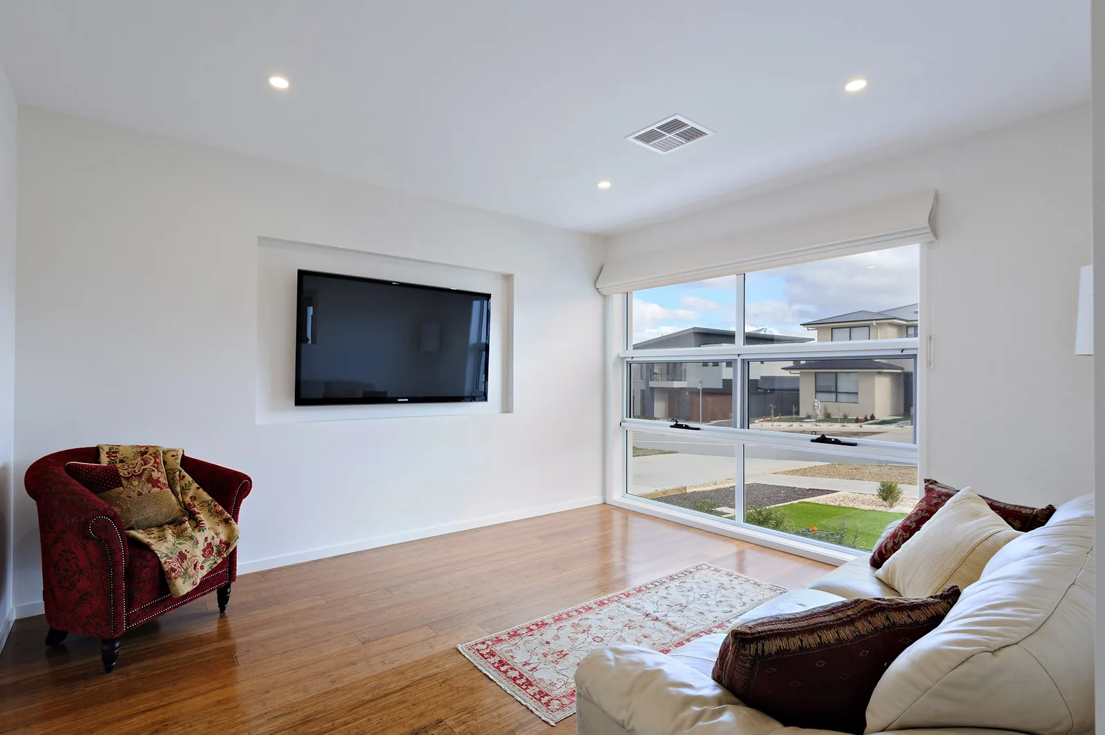 Front lounge room with recessed television nook and street outlook