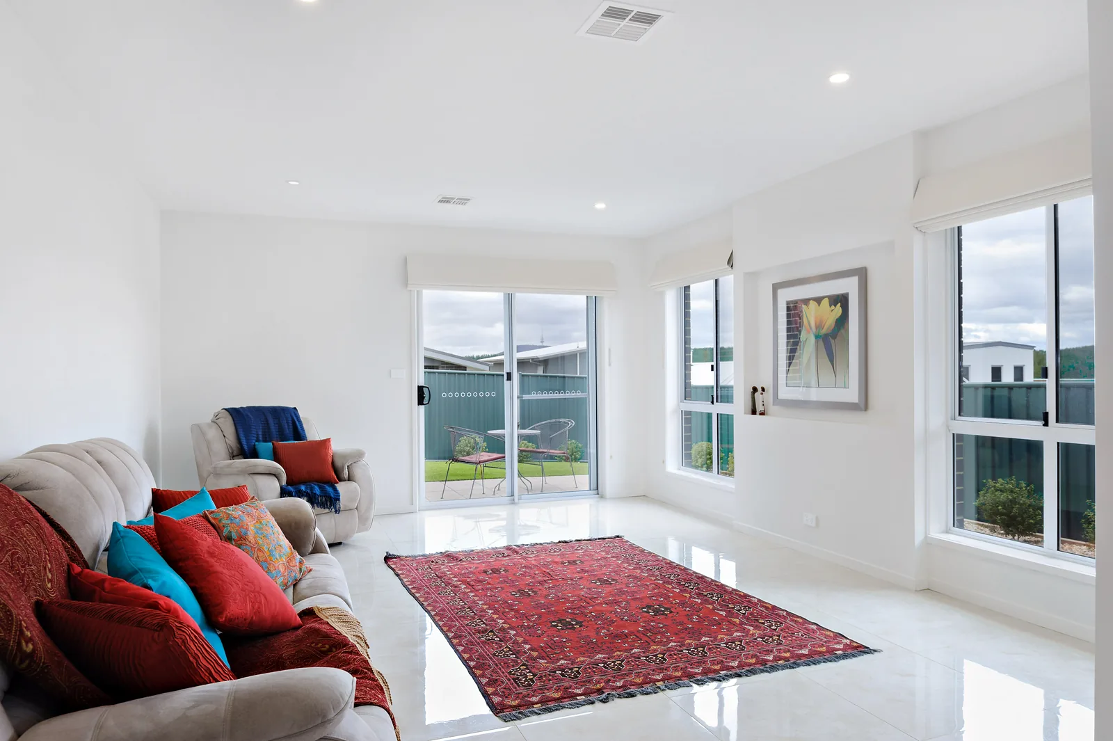 Tiled family room with corner windows opening to the rear garden
