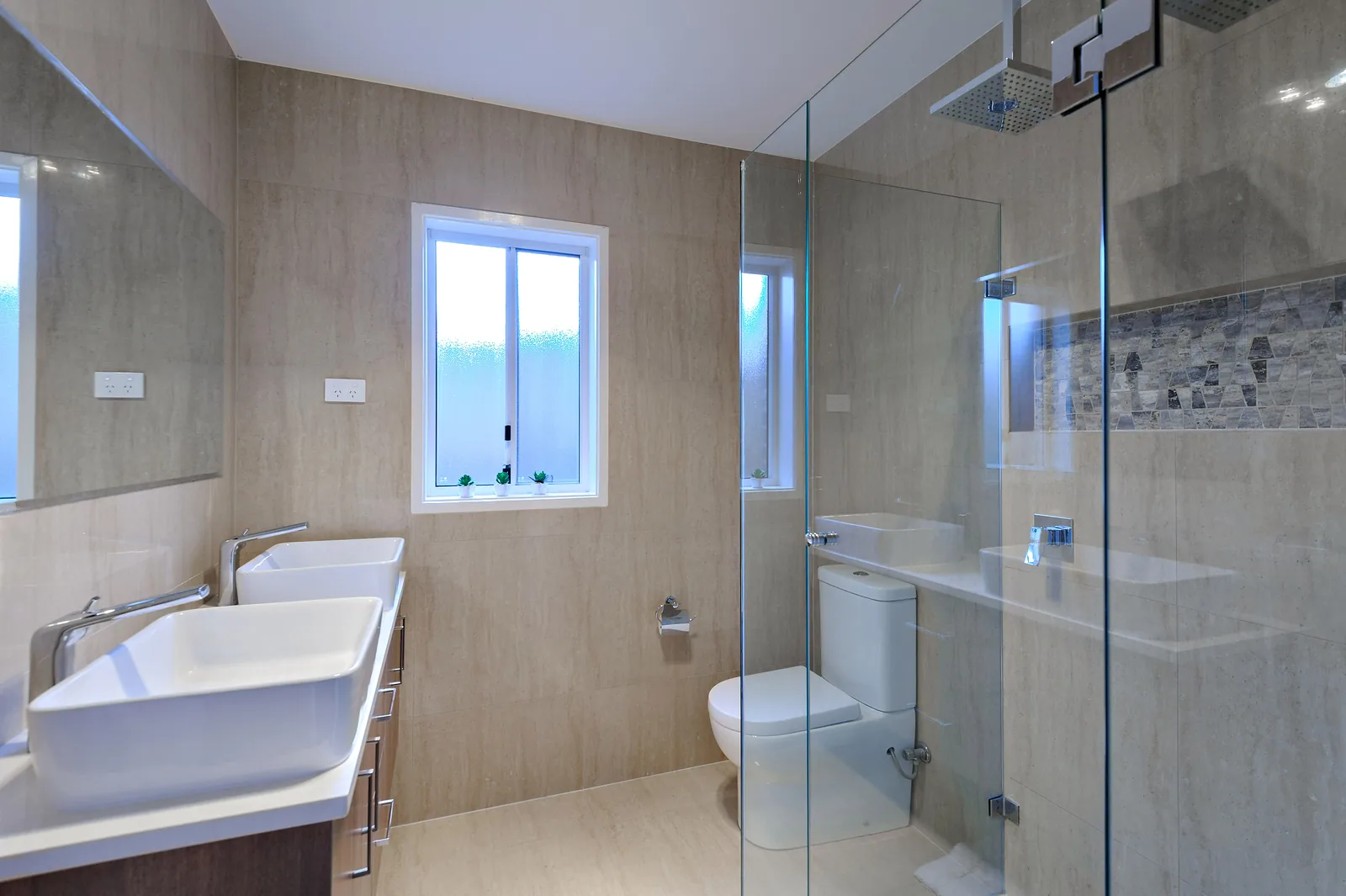Ensuite with twin basins and dual head frameless shower
