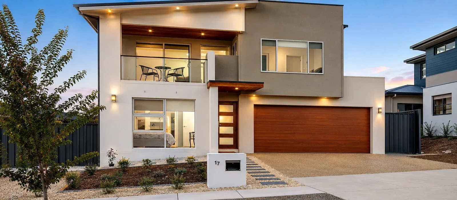 Completed two storey home with balcony at dusk, Wright ACT