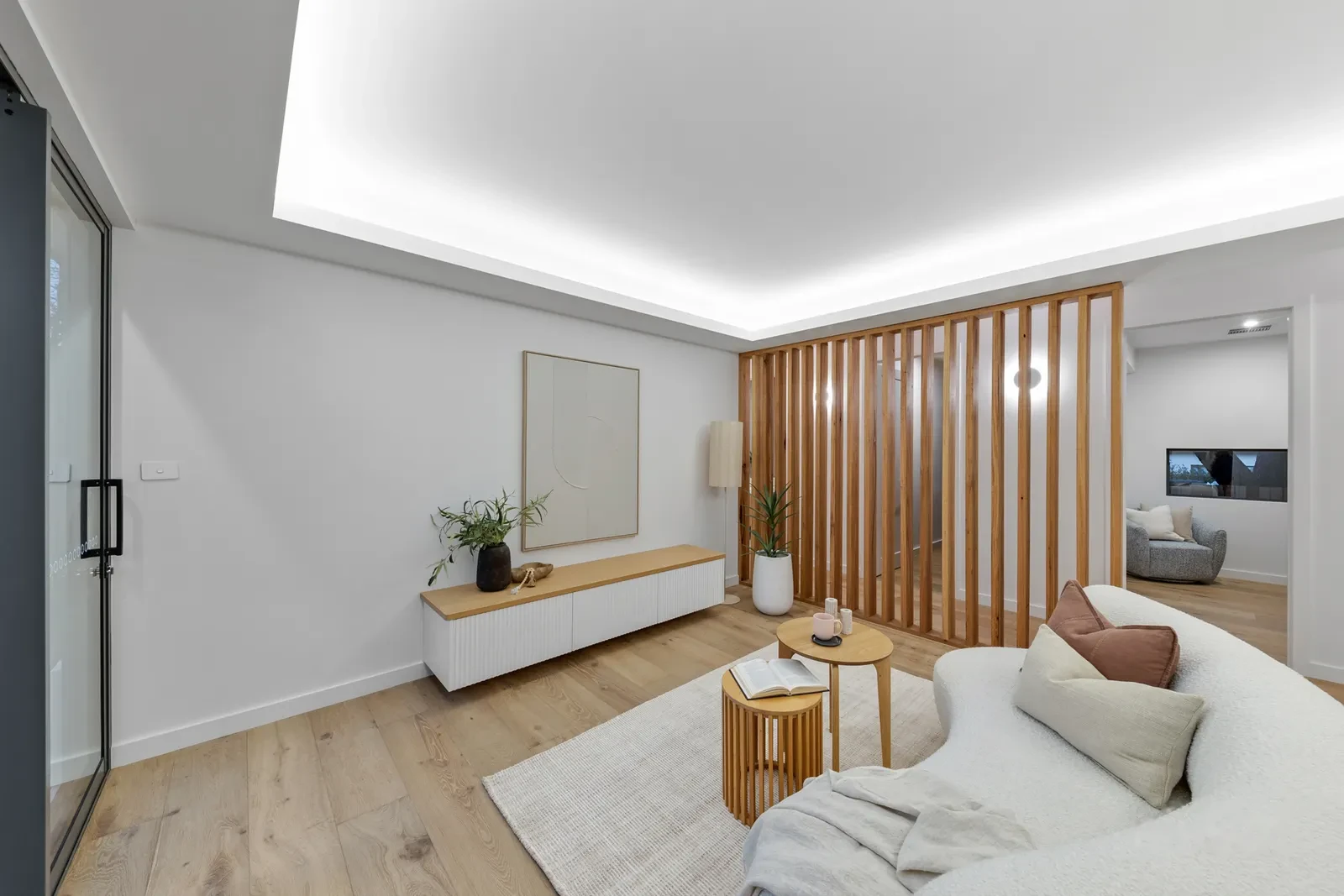 Media room behind a floor to ceiling timber batten screen