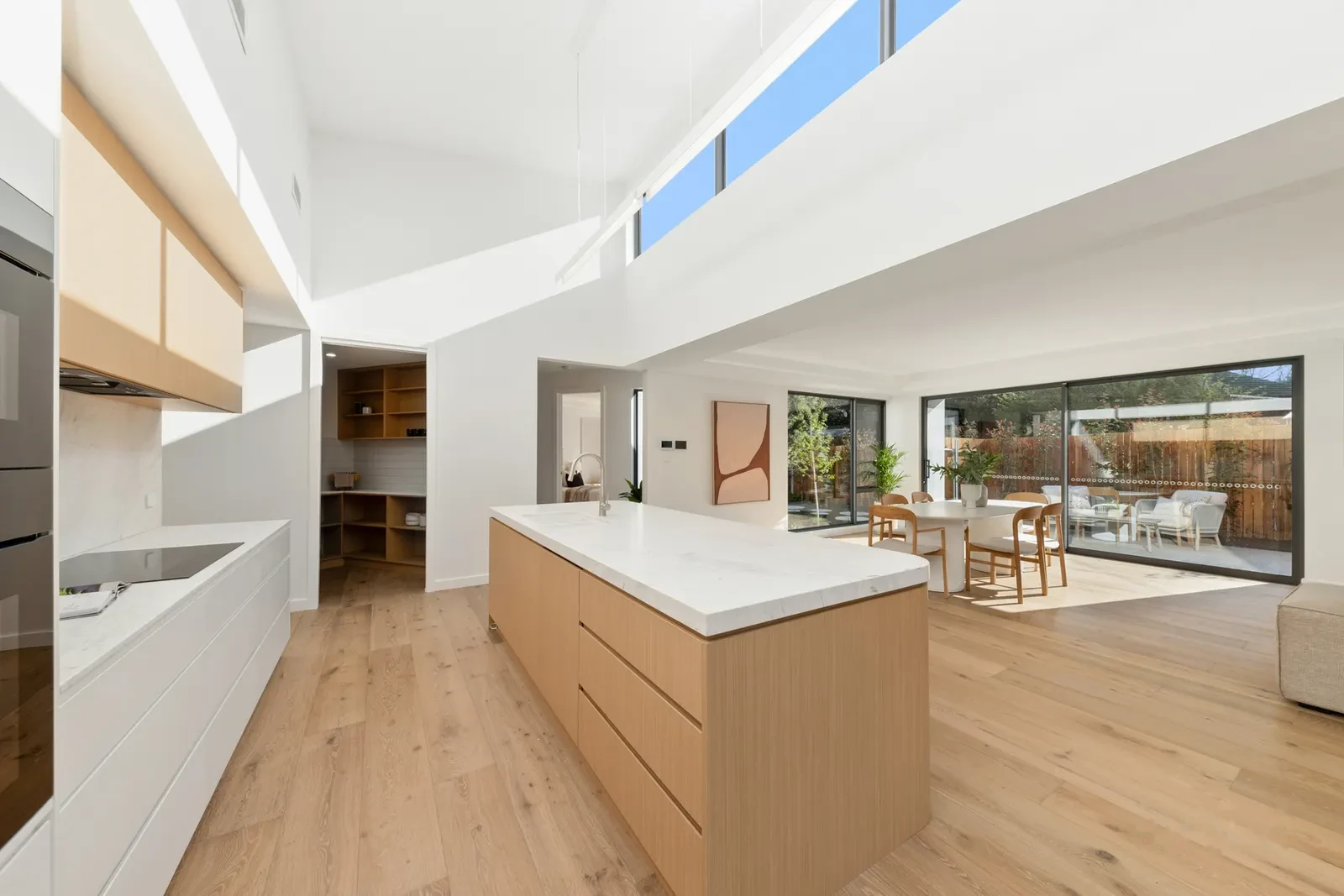 Open plan kitchen and living with sculpted ceiling coves