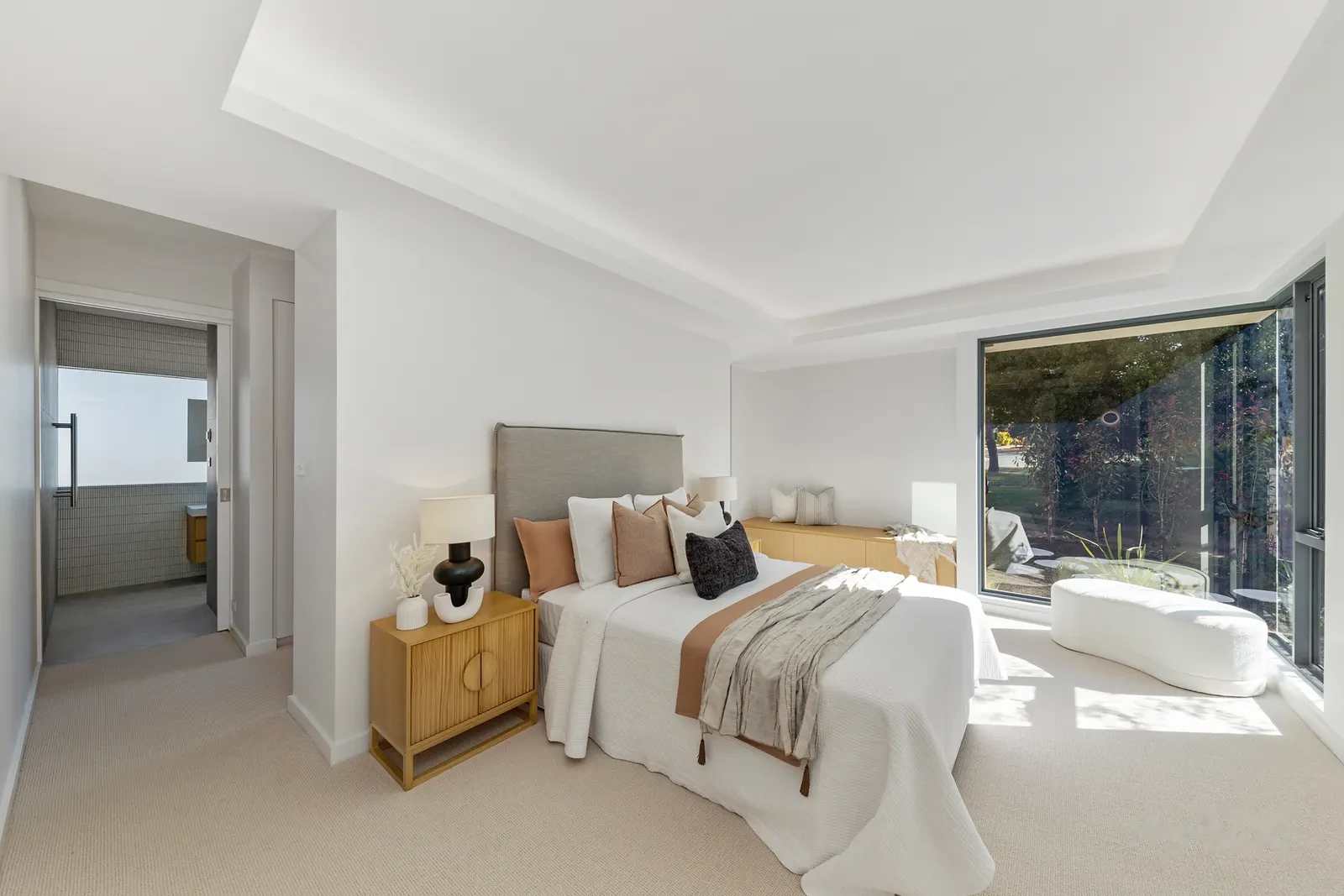 Master bedroom with picture window and upholstered window seat