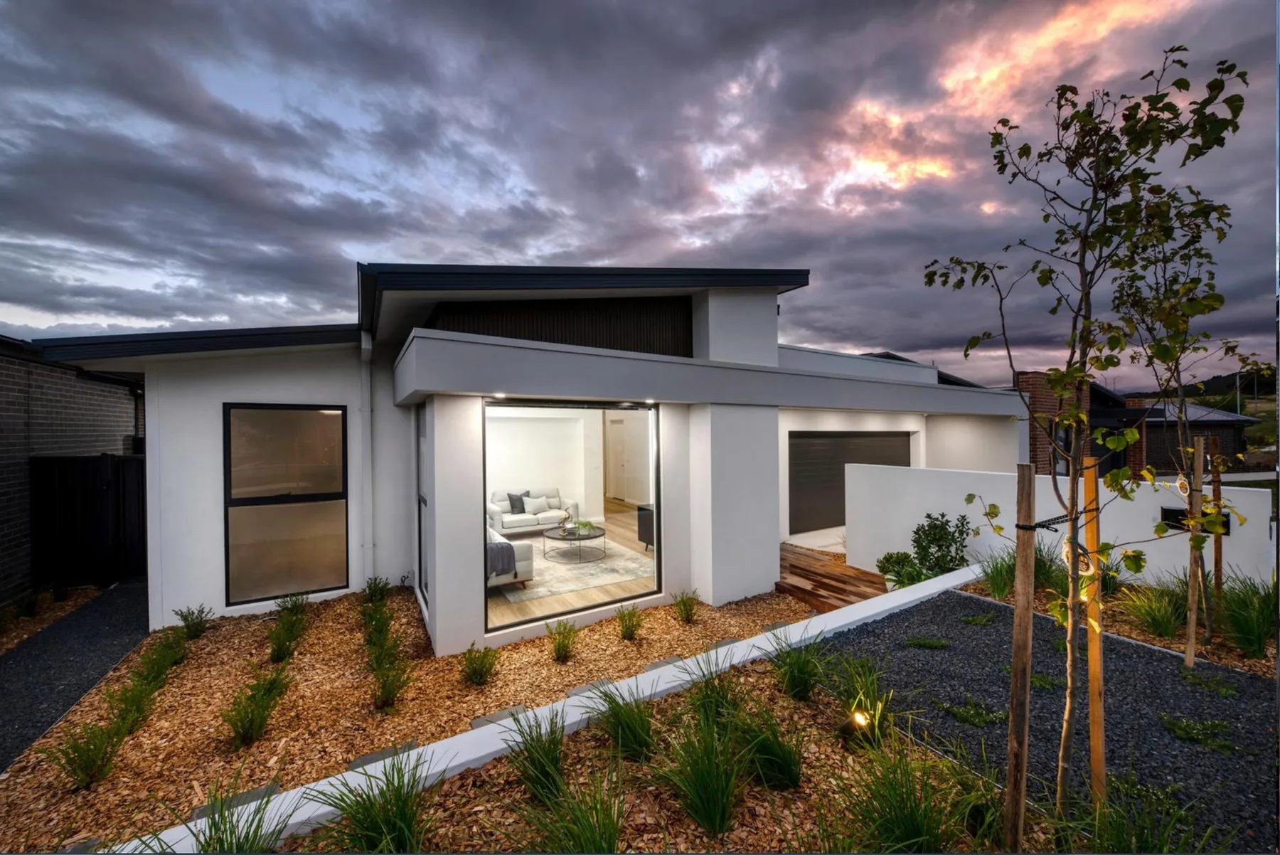 Family home front exterior at twilight by Ottimo Homes