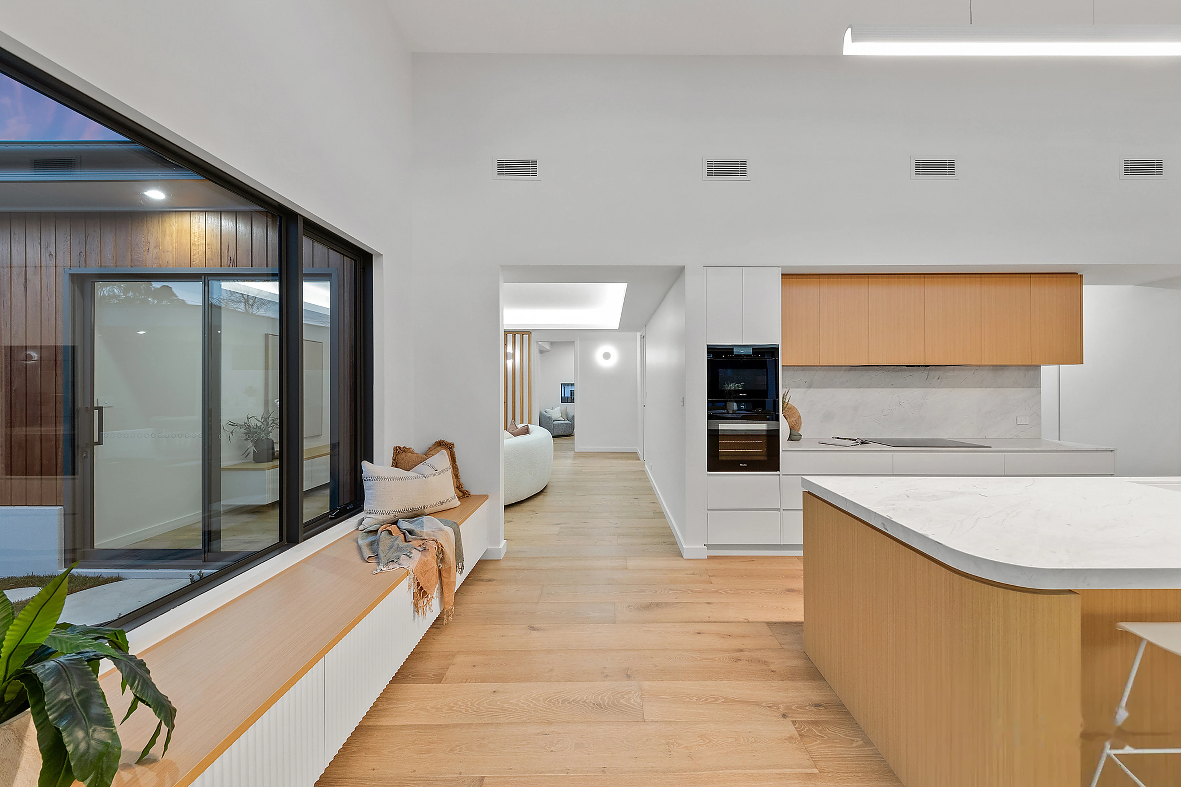 Open plan kitchen and window seat interior, Curtin, by Ottimo Homes