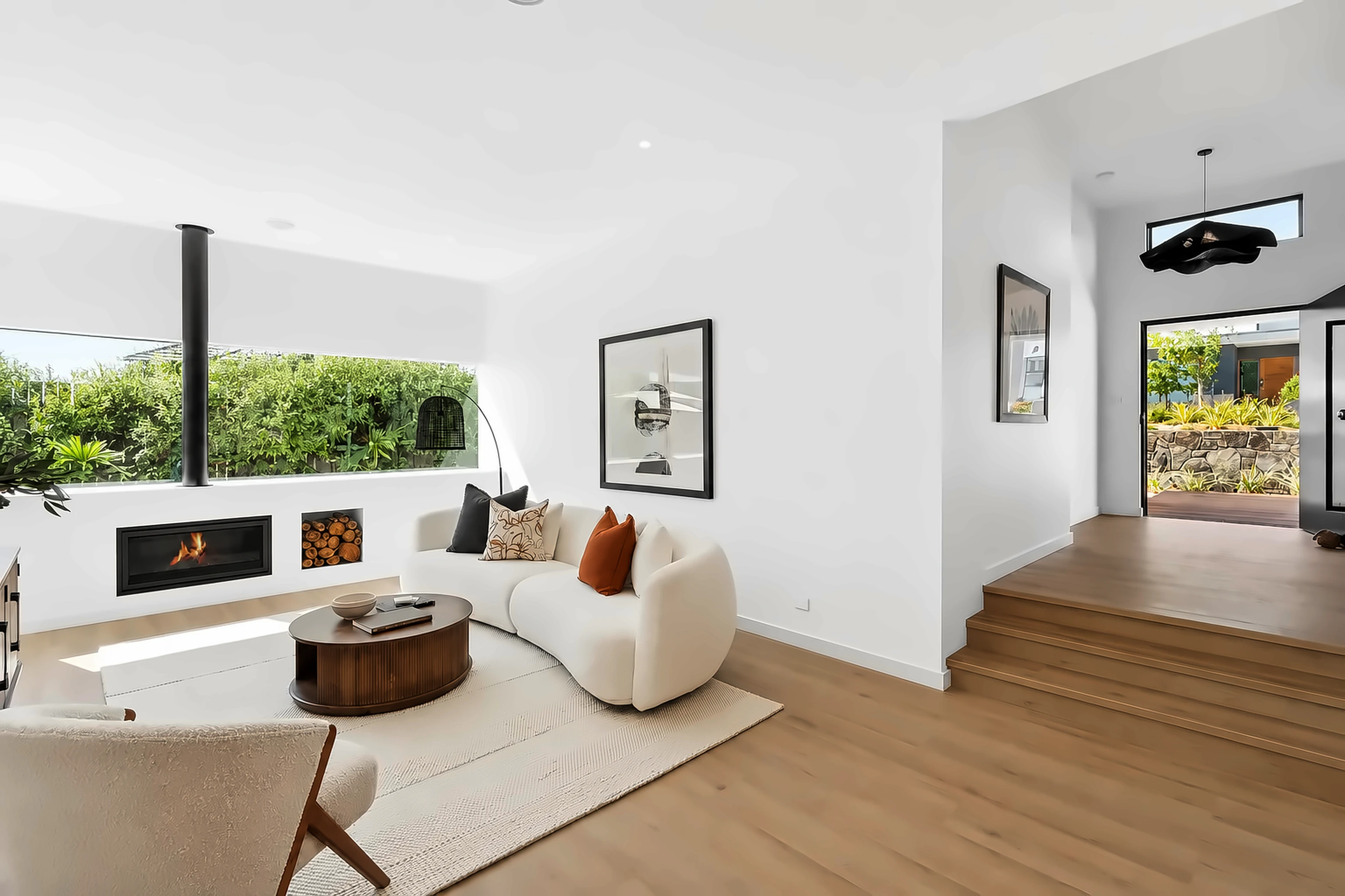 Lounge room with fireplace and garden outlook by Ottimo Homes